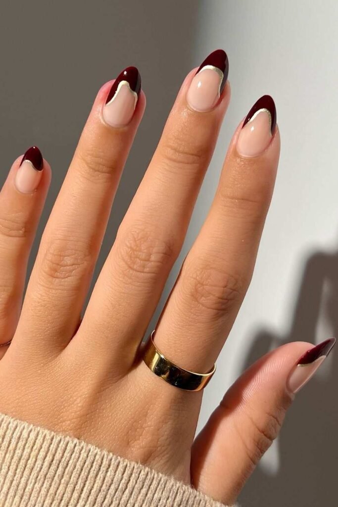 Dark red French nails with abstract metallic silver outlines