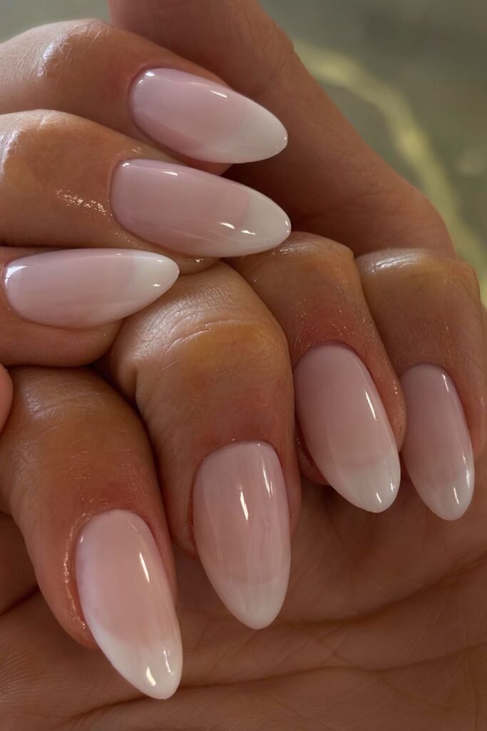 Delicate French nails with translucent pink polish