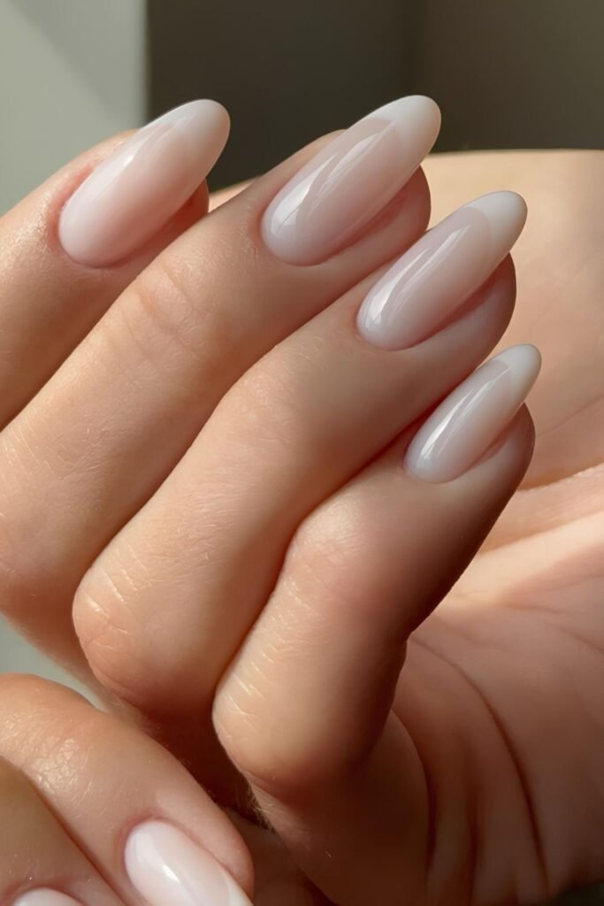 Milky white foggy French nails on long almond tips