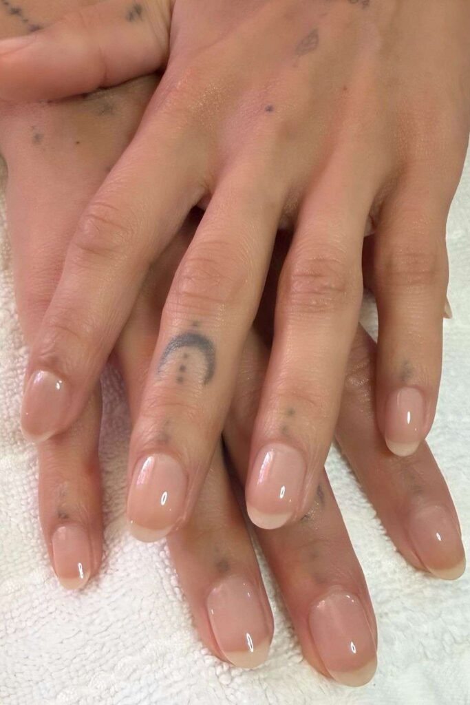 Natural short nails with sheer pink polish and soft white tips
