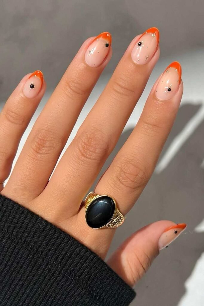 Orange French nails with celestial details