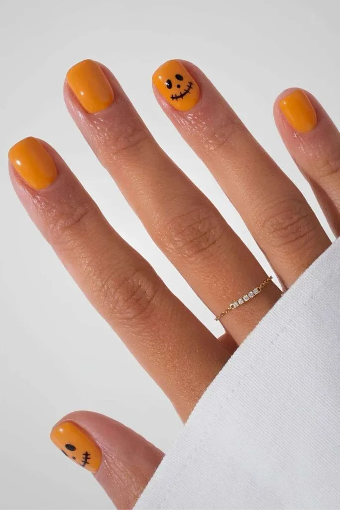 Orange jack-o’-lantern inspired nails