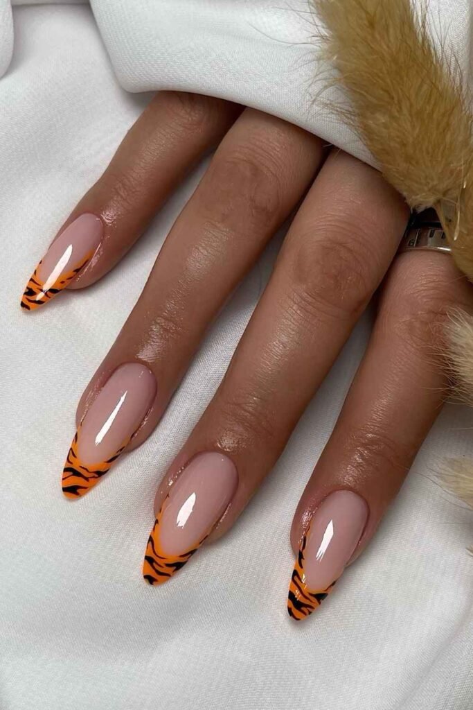 Orange zebra print French nails