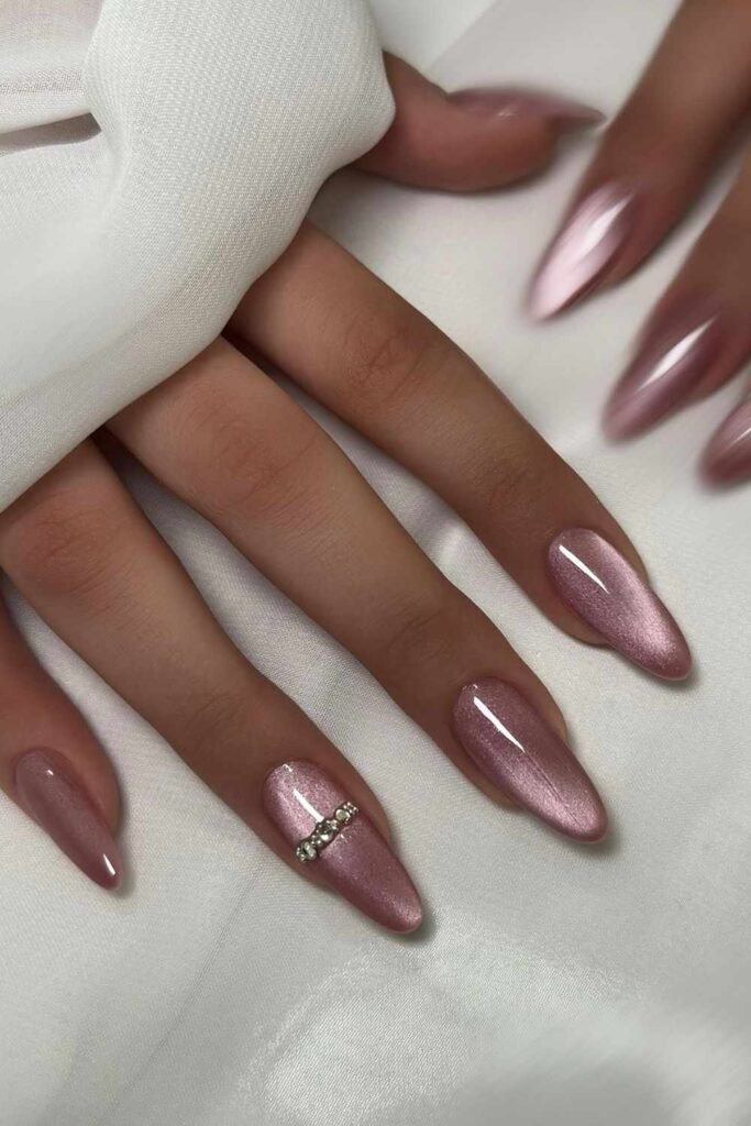 Pink cat-eye nails with crystal accent
