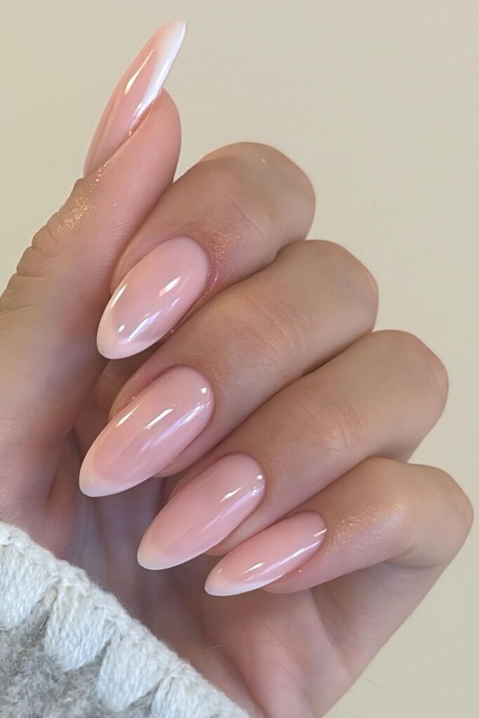 Sheer pink almond nails with subtle milky white tips