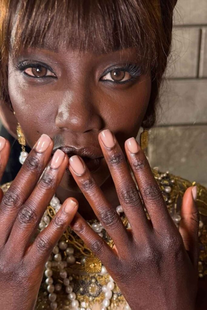 Sheer pink nails on dark skin