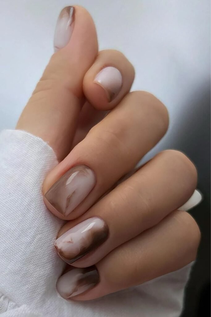 Short milky nails with mocha marble effect