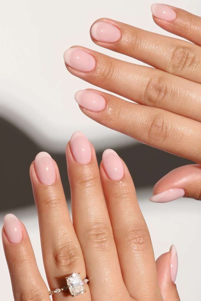 Short oval nails with a soft milky pink manicure